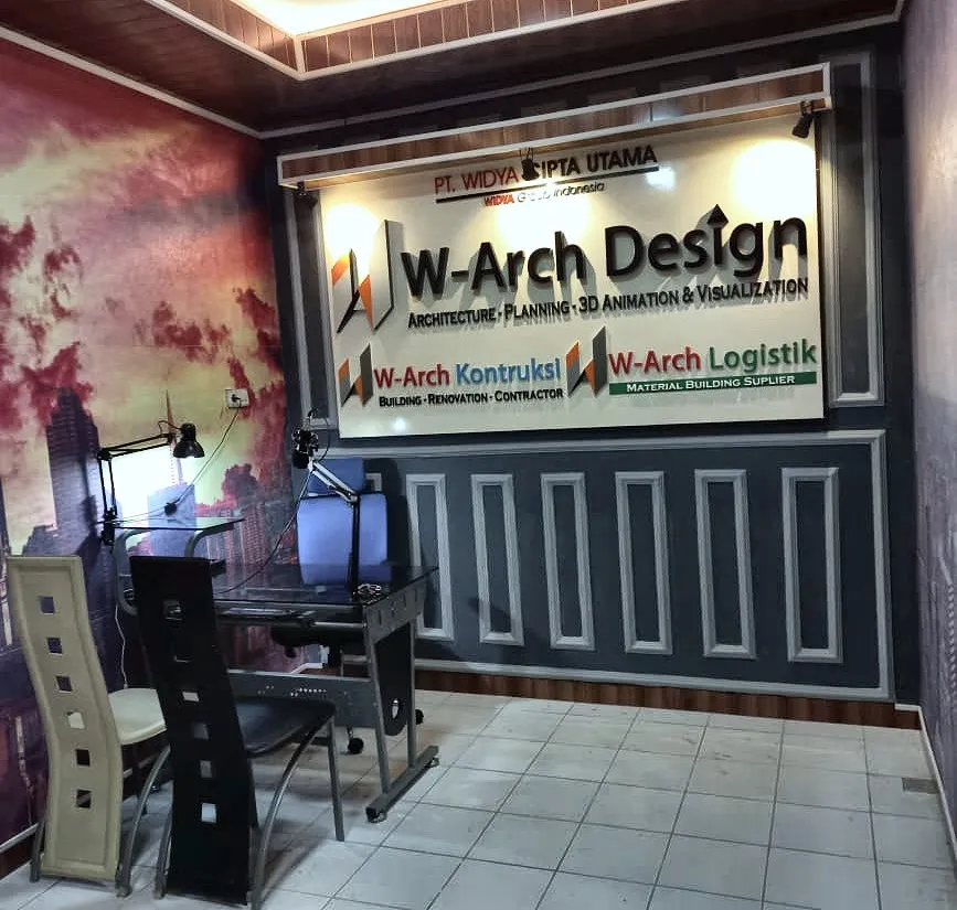 Ruang depan kantor W-Arch Design dengan papan nama tiga unit dan meja kerja